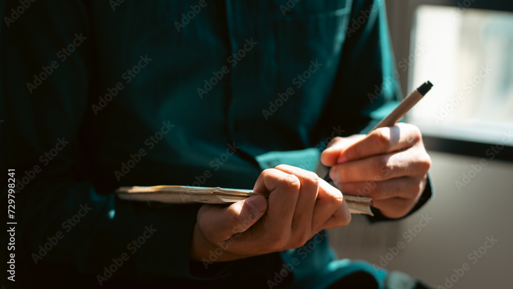 businessman working at work table,home office desk background, checklist writing planning investigate enthusiastic concept. Male hand taking notes on the notepad. - obrazy, fototapety, plakaty 