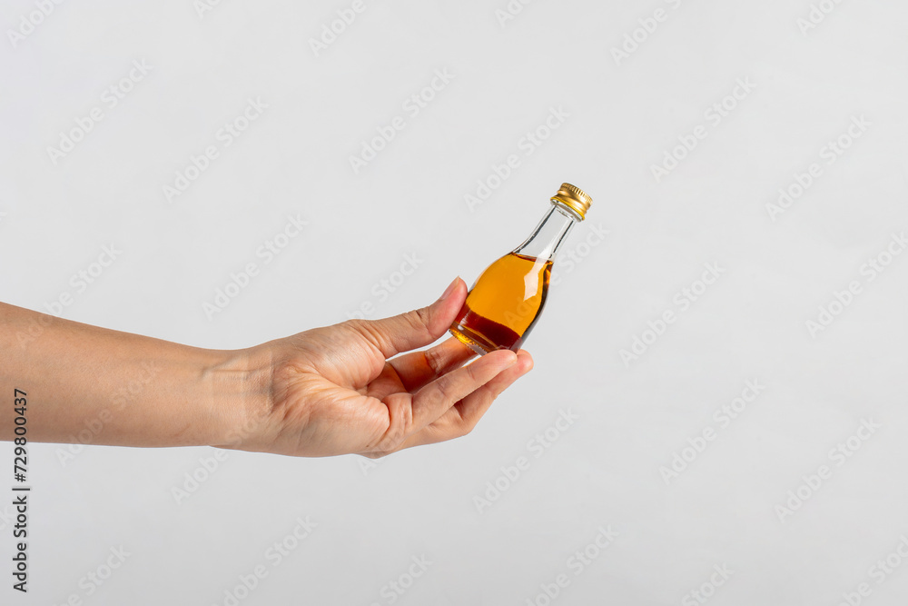 Glass jar with sweet honey in hand isolated on white background Glass jar with sweet honey in hand isolated on white background