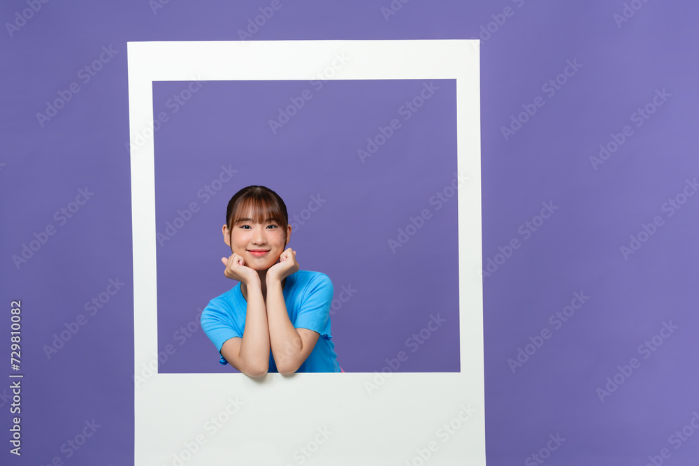 Smiling lady take photo of herself posing on camera isolated on purple background Smiling lady take photo of herself posing on camera isolated on purple background