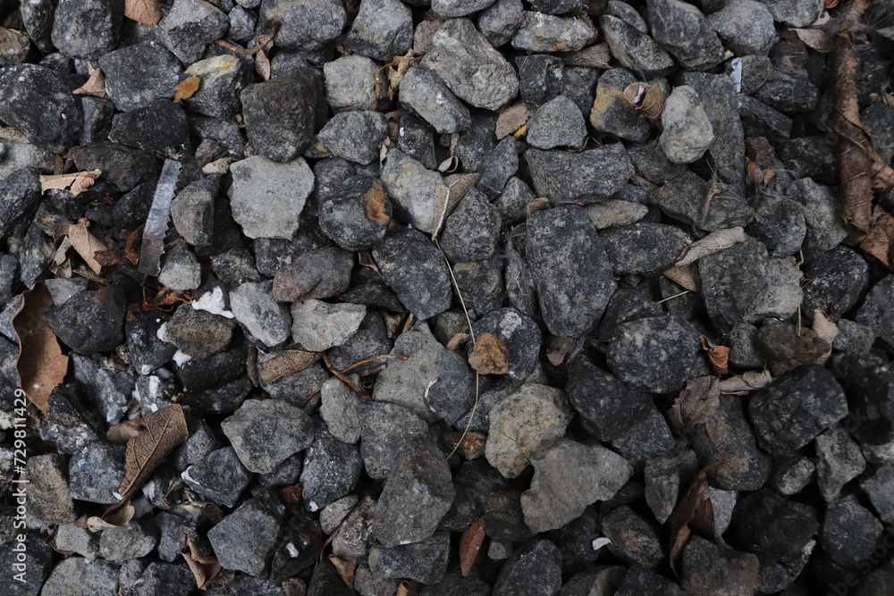 The surface with piles of gravel/stone accompanied by dry leaf fragments, plastic waste fragments and paper fragments The surface with piles of gravel/stone accompanied by dry leaf fragments, plastic waste fragments and paper fragments