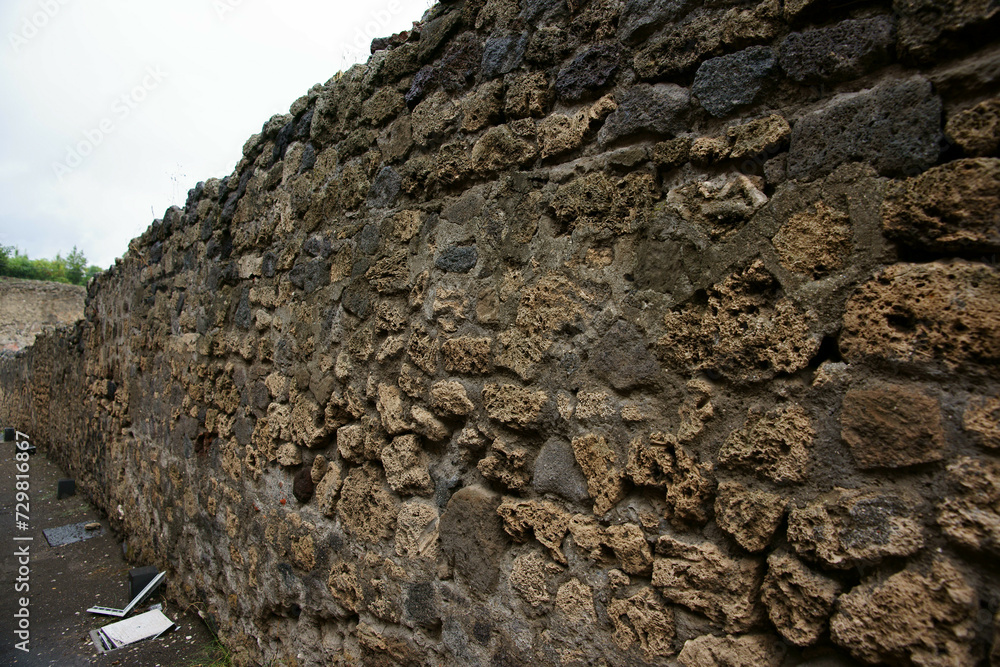 View of typical Roman brick and mortar wall on a rainy morning