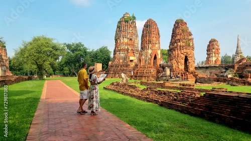 Ayutthaya, Thailand at Wat Mahathat, Temple stupa pagoda ruins in the morning Ayyuthaya Thailand. a couple of man and woman with a tourist map in her hands looking at an old temple in Thailand photo