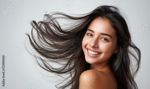 Portrait of a beautiful woman with a bright smile, hair is a beautiful black color, shampoo advertising concept Hair conditioner and cosmetic products,Generative AI