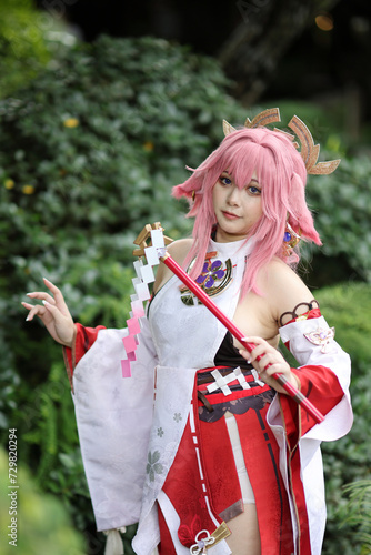 Portrait of a beautiful young woman game cosplay on japanese garden