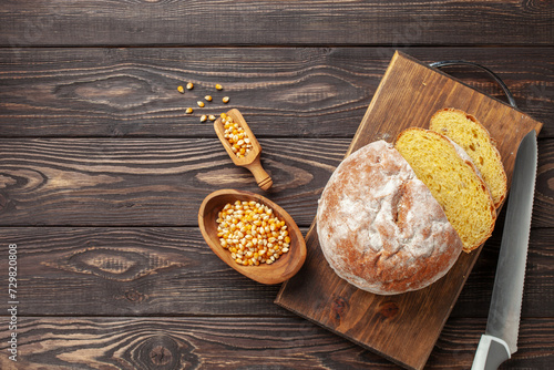 Fresh cornbread and corn grains on the table. Food grain crisis concept. Top view