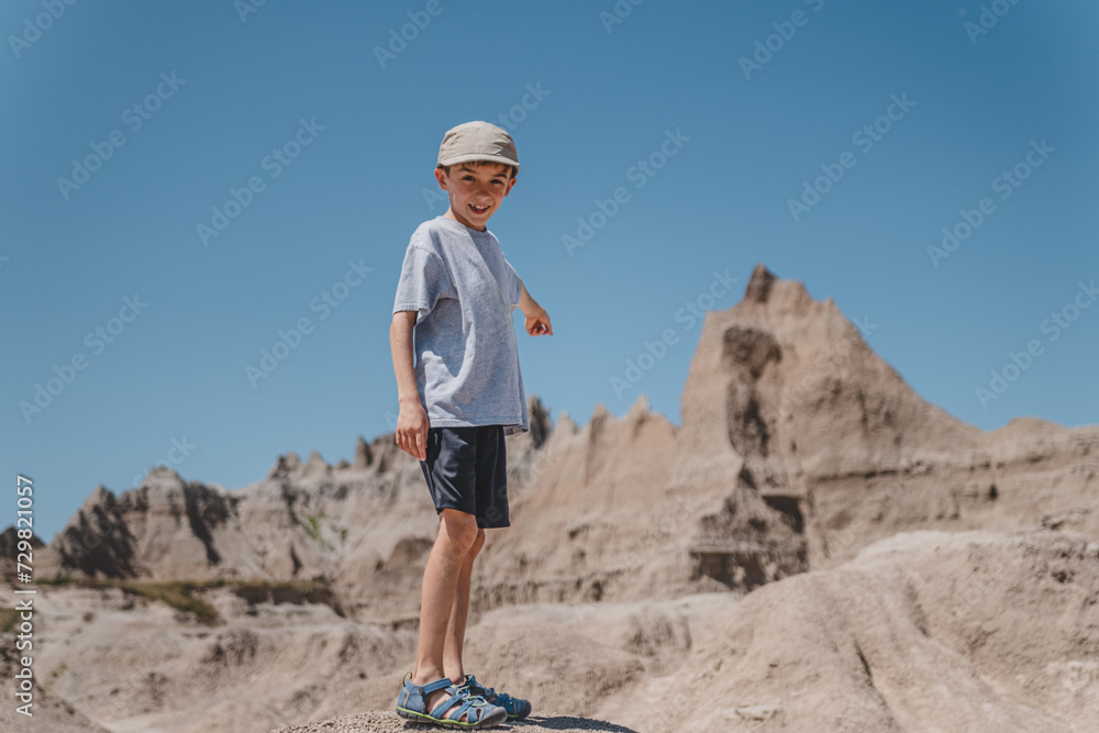 Young boy exploring the rock formations of Badlands National Park Young boy exploring the rock formations of Badlands National Park
