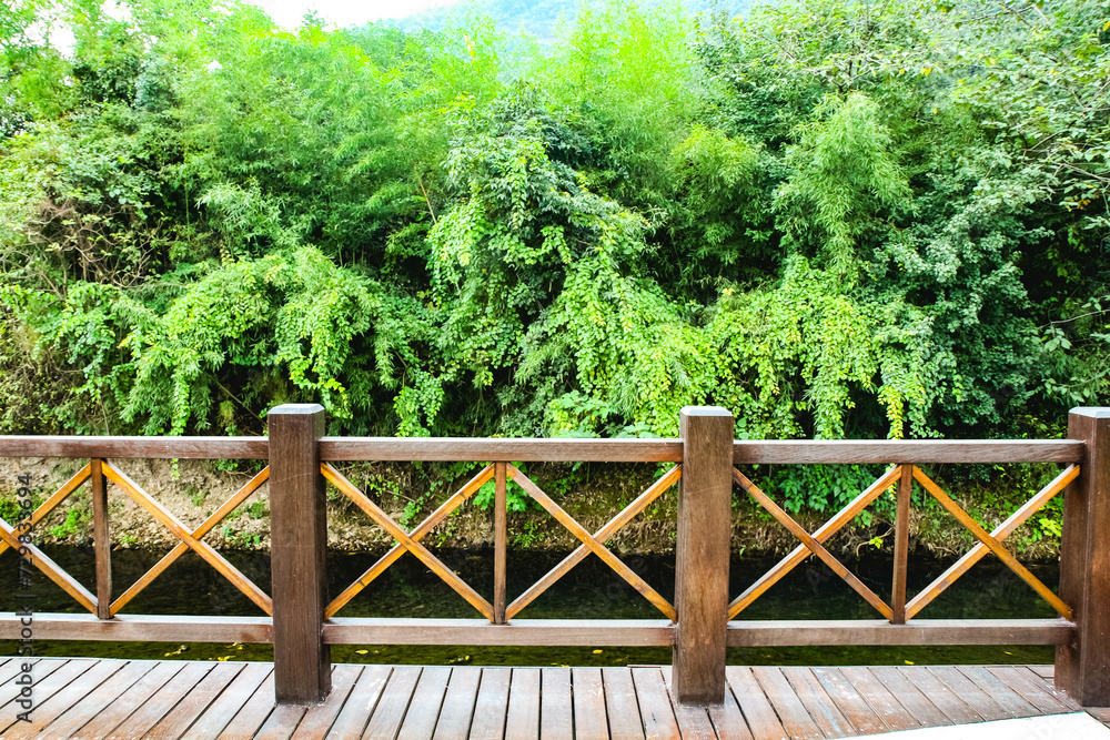 Wood bridge over lake, wooden bridge in the park.The bridge built, beautiful wood bridge background is green garden at the summer.