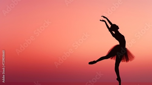  a silhouette of a ballerina in front of a pink and orange sky with a silhouette of a ballerina in the foreground with her arms in the air.
