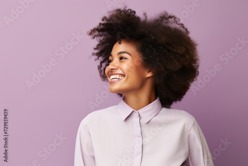 Beautiful african american woman with afro hairstyle on purple background