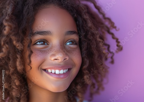 little African American girl with colorful sweatshirt in professional colorful photo studio background