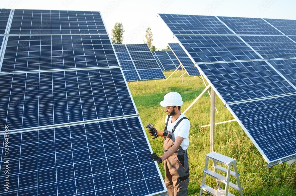 Indian man in uniform working near solar panel. Indian man in uniform working near solar panel.