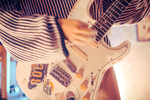 Fototapet Closeup white stratocaster guitar with stickers from live show