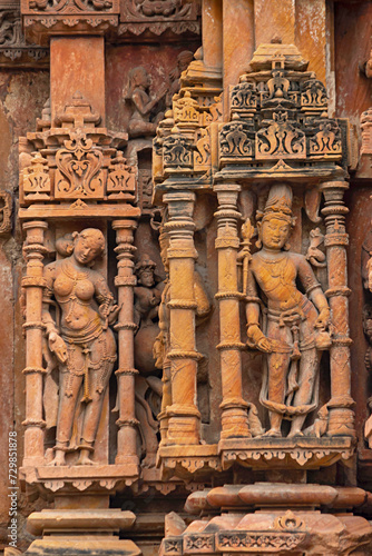 Carving Sculpture of Lord Shiva in Form of Bhikshadanar and Woman Carving in Side, Sun Temple of Jhalarapatan, Rajasthan, India.