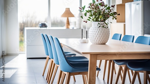 Modern Scandinavian dining room with wooden table and blue chairs