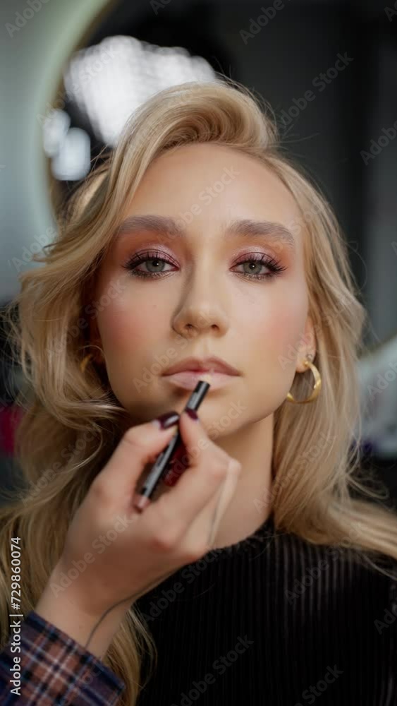 Makeup Artist Outlining Lips on Client Makeup Artist Outlining Lips on Client