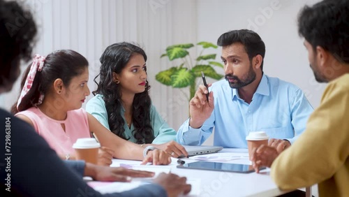 Businessman or team manager explaining about project to group of coworkers at office meeting - concept of leadership planning, expert advice and consultation