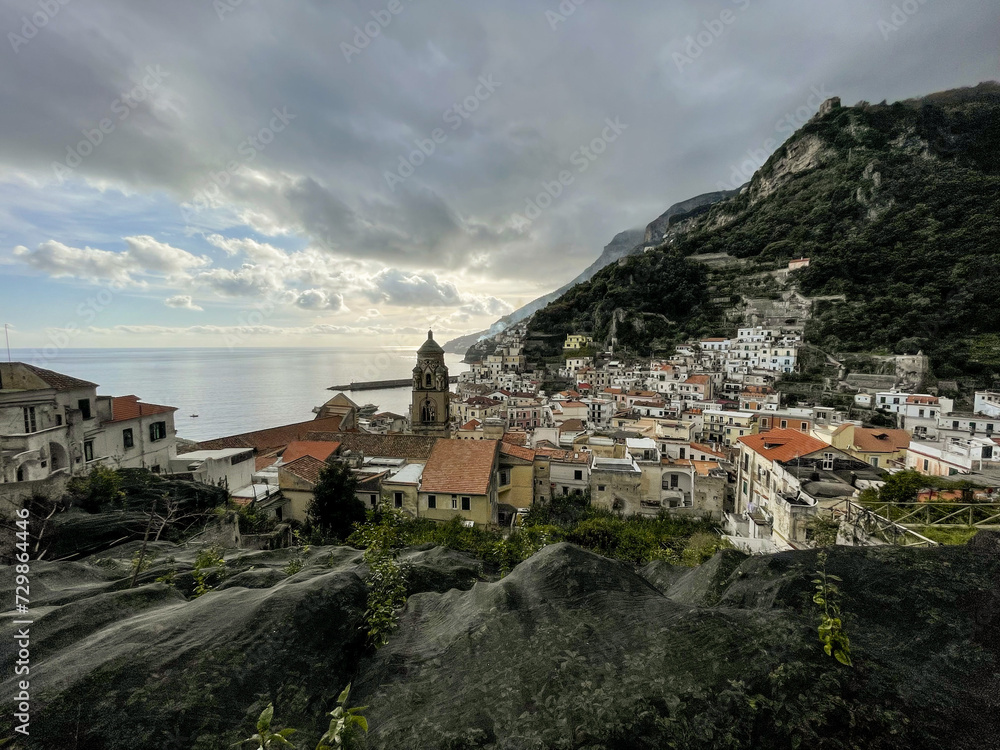 Fototapeta premium Amalfi, Amalfi coast, Salerno, Italy. glimpses of Amalfi, the town between lemon groves and the Lattari mountains, view of the Amalfi cathedral with its bell tower with the sea