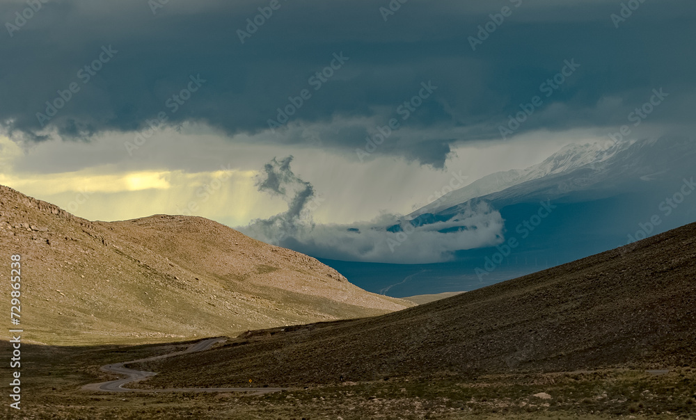 Spectacular landscape in the Peruvian Altiplano in the Andes Mountains between Cabanaconde and Arequipa, Peru, hills. Storm, dramatic sky.