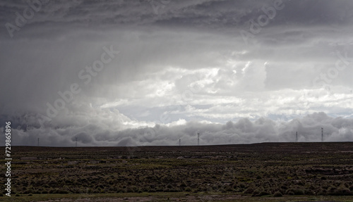 Spectacular landscape in the Peruvian Altiplano in the Andes Mountains between Cabanaconde and Arequipa, Peru, hills. Storm, dramatic sky. Chiaroscuro.