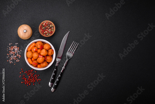 Delicious fried potato balls with vegetables, salt, spices and herbs