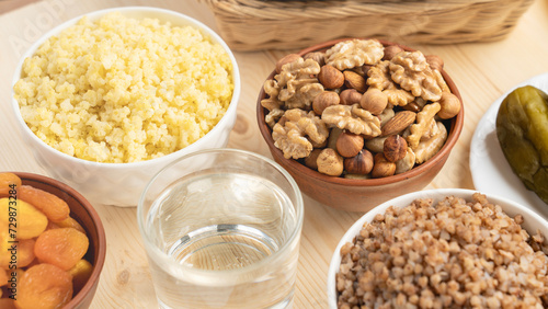 A mixture of nuts and cereal porridge on a wooden table, healthy and wholesome food concept