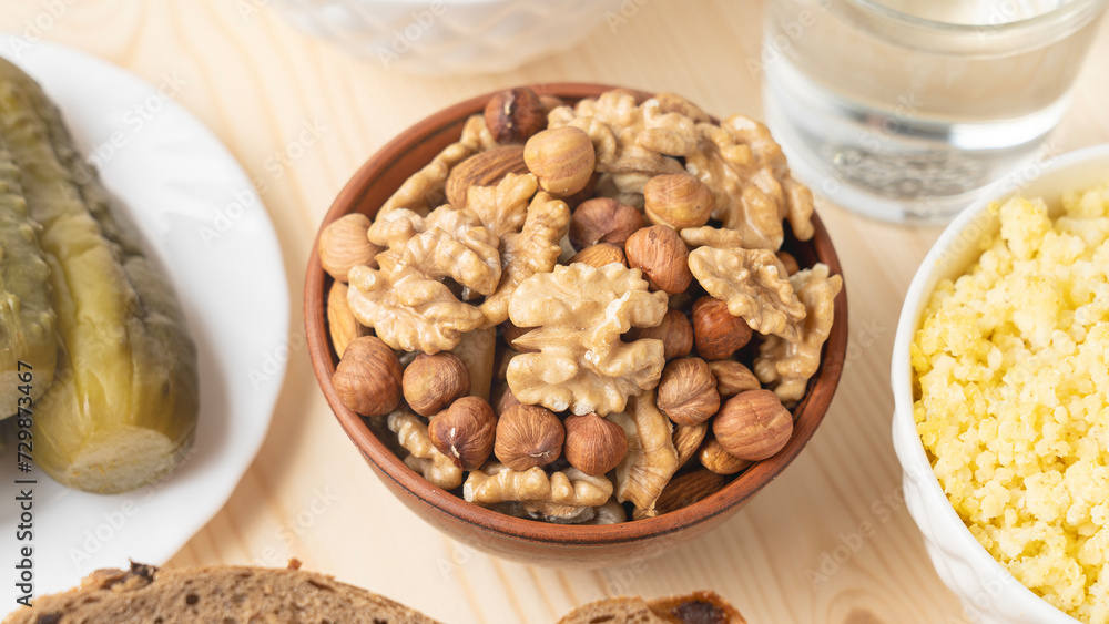 A mixture of nuts and cereal porridge on a wooden table, healthy and wholesome food concept A mixture of nuts and cereal porridge on a wooden table, healthy and wholesome food concept