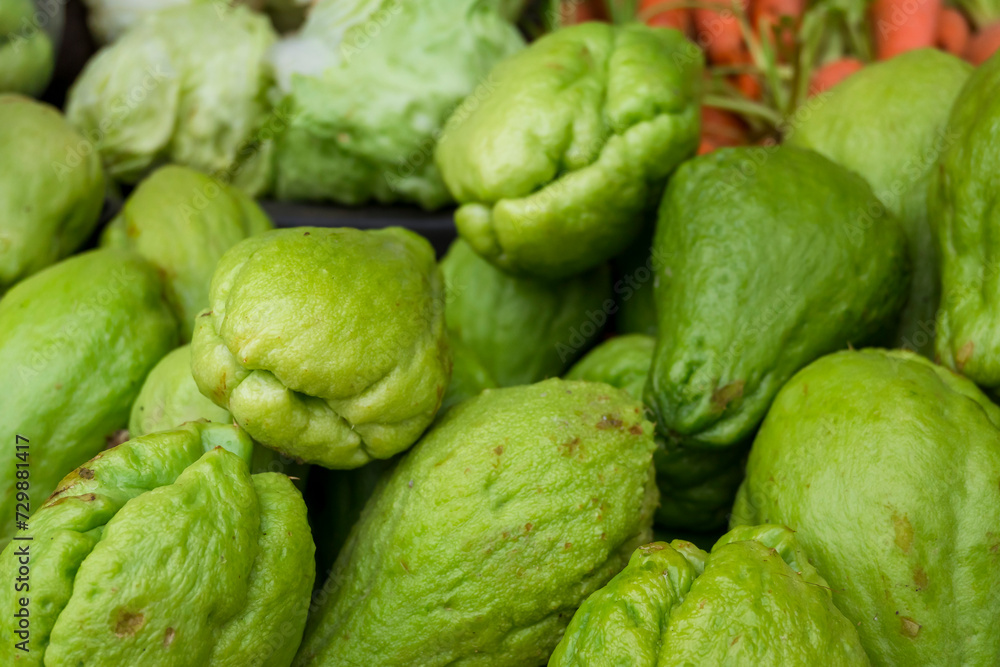 Close-up of vibrant green chayote squash heaped on a market stall, showcasing healthy, organic produce. At Hungduan, Ifugao Province. Close-up of vibrant green chayote squash heaped on a market stall, showcasing healthy, organic produce. At Hungduan, Ifugao Province.