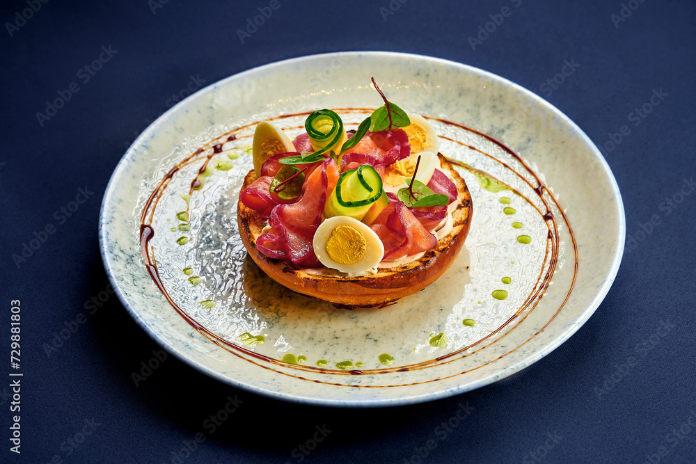 Toast with salmon and vegetables in a plate Toast with salmon and vegetables in a plate