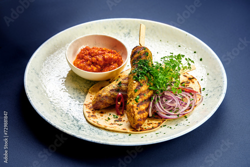 Turkish Lula kebab with pita bread and sauce in a plate