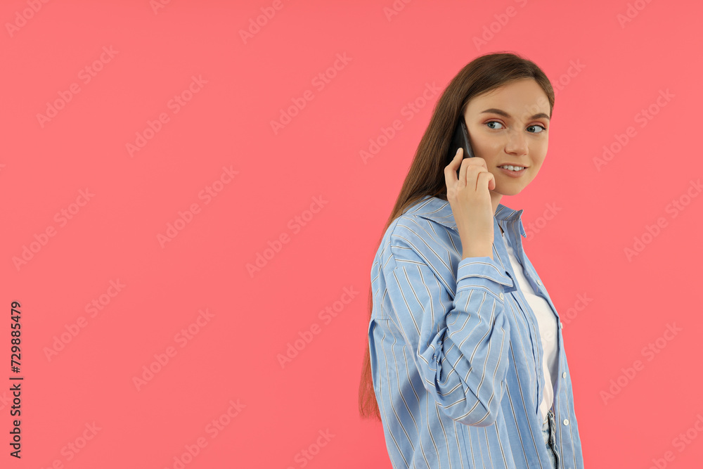 An attractive young girl holds a smartphone in her hands An attractive young girl holds a smartphone in her hands