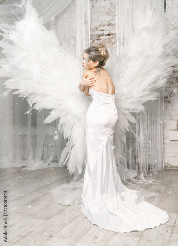 Girl in a white dress with angel snouts