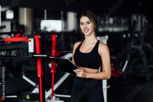 Attractive Sports Girl Personal Trainer Middle Modern Gym With Workout Plan Her Hands