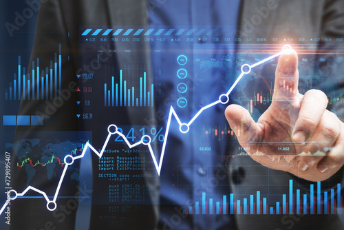 Close up of man hand drawing business chart and map on blurry office interior background. Financial forecast and trade concept. Double exposure.