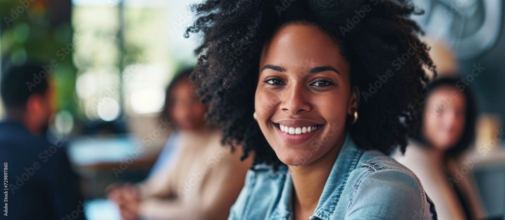 Young professional woman smiling at camera during office conference. Young professional woman smiling at camera during office conference.