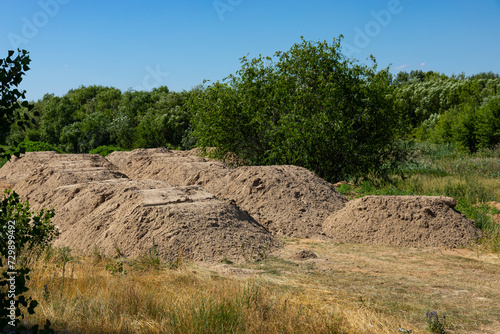 Construction sand. Mountain of sand on construction site. Excavated earth.