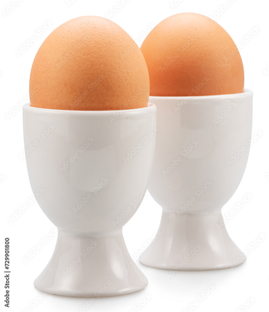 Brown chicken eggs in the egg cups isolated on white background. File contains clipping paths. Brown chicken eggs in the egg cups isolated on white background. File contains clipping paths.