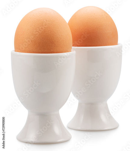 Brown chicken eggs in the egg cups isolated on white background. File contains clipping paths.