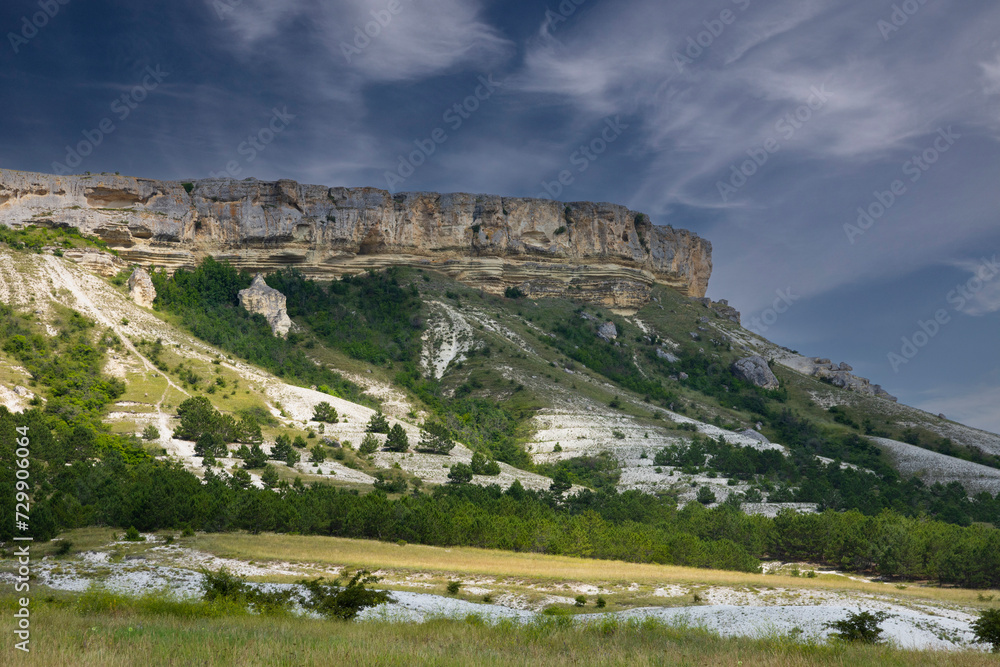 Mountainous, rocky landscape of the canyon with the top of the White Rock against the blue sky.