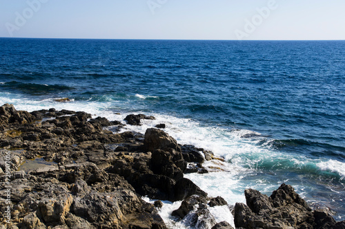 Sea coast with dark stones, landscape