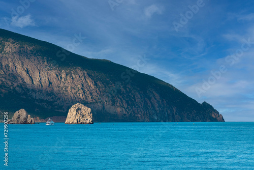 Seascape, mountains and rocks surrounded by water at sunset. Black Sea