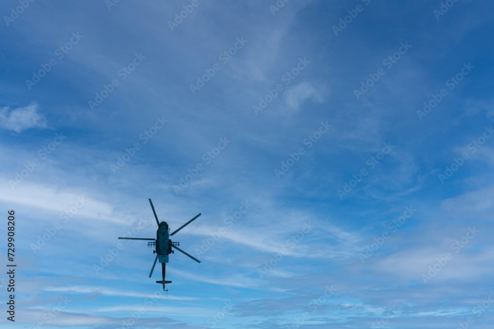 Military Russian helicopter flies in the sky. Bottom view. Military Russian helicopter flies in the sky. Bottom view.