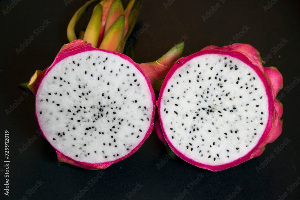 Dragon fruit sliced in two piece with the Background Dragon fruit sliced in two piece with the Background