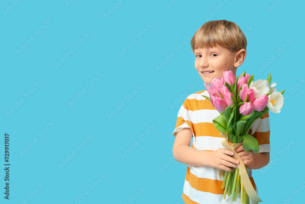 Cute little boy with bouquet of beautiful tulips on blue background. International Women's Day Cute little boy with bouquet of beautiful tulips on blue background. International Women's Day