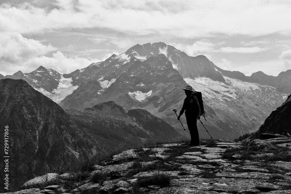 Silhouette of a hiker in front of the summit of Monte Disgrazia, black and white photo, Valmalenco, Italian mountains, Lombardy, Alps, Italy, Europe