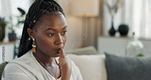 Stress, anxiety and woman biting nails in home with fear, worry and mental health risk. Face of african girl in living room with crisis of trauma, nervous habit and overthinking with doubt of mistake photo