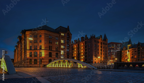 Arch bridge over canals with cobbled road in the Speicherstadt of Hamburg, Germany, Europe.