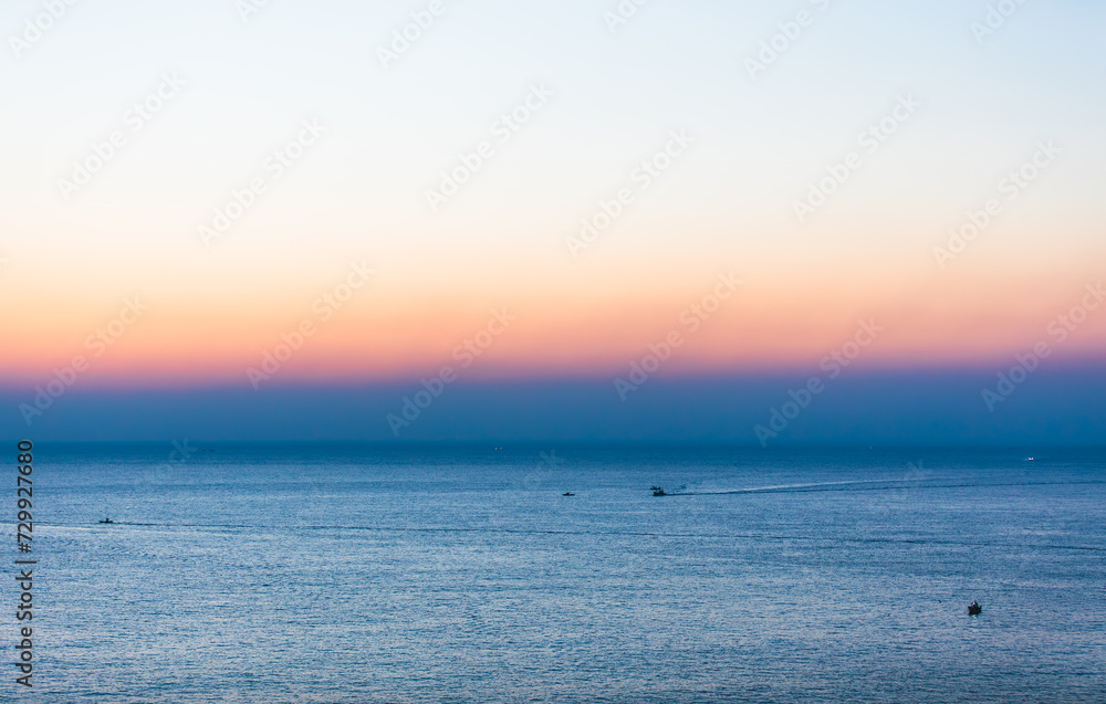 Obraz premium Dawn scenery of the sea. Fishing boats departing early in the morning