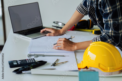 architect man working with laptop and blueprints,engineer inspection in workplace for architectural
