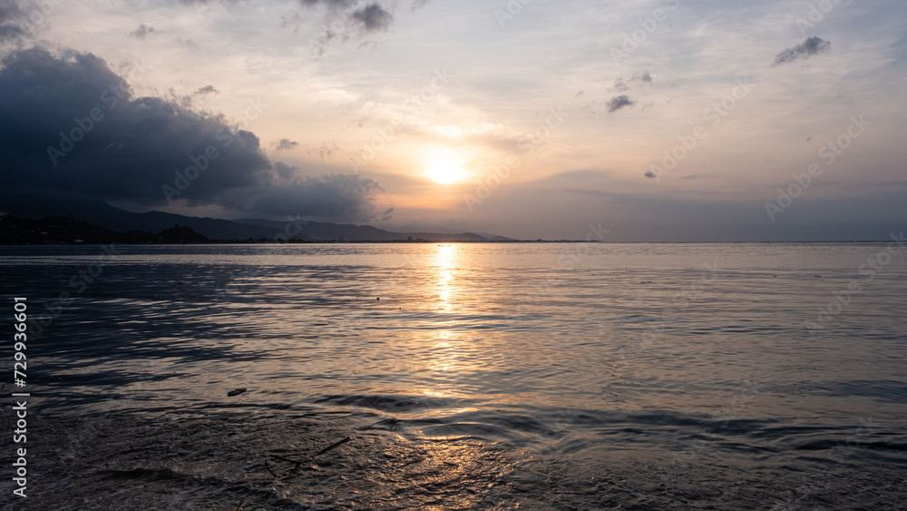 Scenic landscape of golden sunset reflecting over ocean on tropical island of Timor-Leste in Southeast Asia