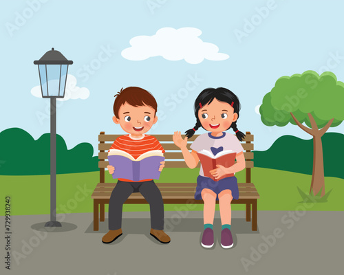 Cute kids reading books discussing sitting on bench at the park